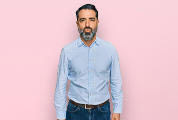 Obraz premium Middle aged man with beard wearing business shirt looking at the camera blowing a kiss on air being lovely and sexy. love expression.