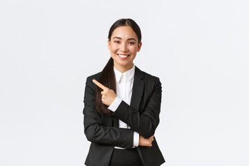 Happy professional asian female manager, businesswoman in suit showing announcement, smiling and...