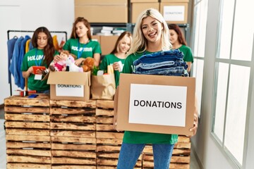 Group of young volunteers woman smiling happy working at charity center.