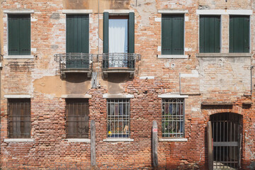 Fototapeta na wymiar Wall and windows of traditional Venetian houses, Venice, Italy