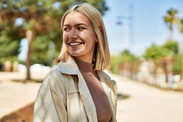 Fototapeta premium Young blonde girl smiling happy standing at the city.