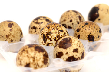 small speckled quail eggs isolated on white background