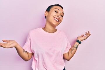 Beautiful hispanic woman with short hair wearing casual pink t shirt clueless and confused...