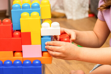 kid, child hands, while playing with educational toy blocks constructor