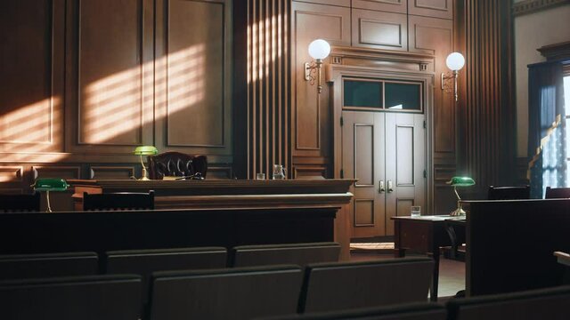 Empty American Style Courtroom. Supreme Court of Law and Justice Trial Stand. Courthouse Before Civil Case Hearing Starts. Grand Wooden Interior with Judge's Bench, Defendant's and Plaintiff's Tables.