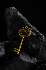 Antique Golden Key on Dark Textured Surface Background