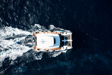View from above, stunning aerial view of a catamaran sailing on a blue water. Costa Smeralda,...