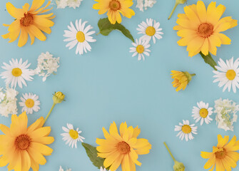 Fototapeta na wymiar Creative joyful summer layout of flowers of white and yellow daisies ,false sunflower on a blue background