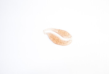 Smear of orange sugar scrub for body and lips are isolded on a white background. Texture of cosmetic body scrub orange color