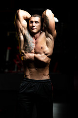 Fototapeta na wymiar Healthy Adult Man Flexing Vacuum Abdominal Muscles
