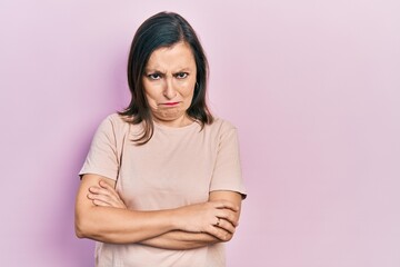 Obraz premium Middle age hispanic woman with arms crossed gesture skeptic and nervous, frowning upset because of problem. negative person.