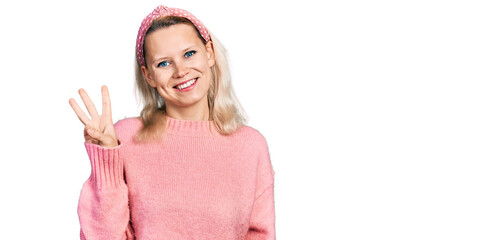 Young caucasian woman wearing casual clothes showing and pointing up with fingers number three while smiling confident and happy.