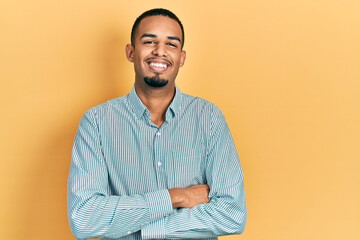 Young african american man wearing casual clothes happy face smiling with crossed arms looking at the camera. positive person.