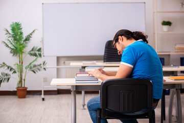 Young male student in the classroom