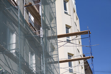 Scaffolding on building house in the city.