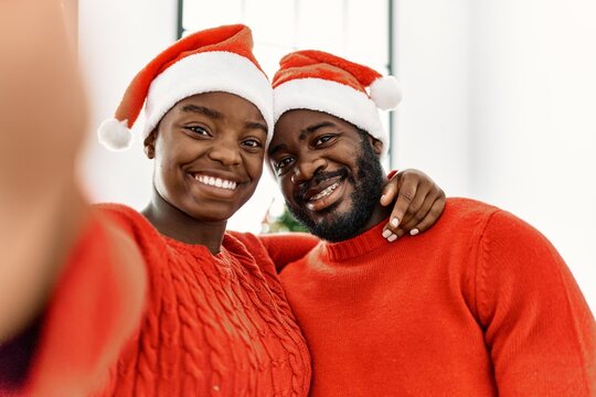 Young african american couple smiling happy make selfie by the camera at home.