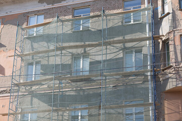 Scaffolding on building house in the city.