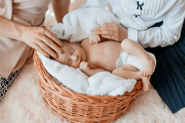 mother and her daughter next to a newborn baby .