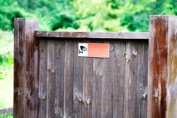 Information board made of wood in the park, with a video surveillance icon