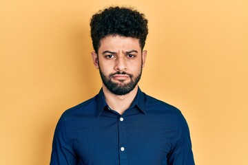 Young arab man with beard wearing casual shirt depressed and worry for distress, crying angry and afraid. sad expression.