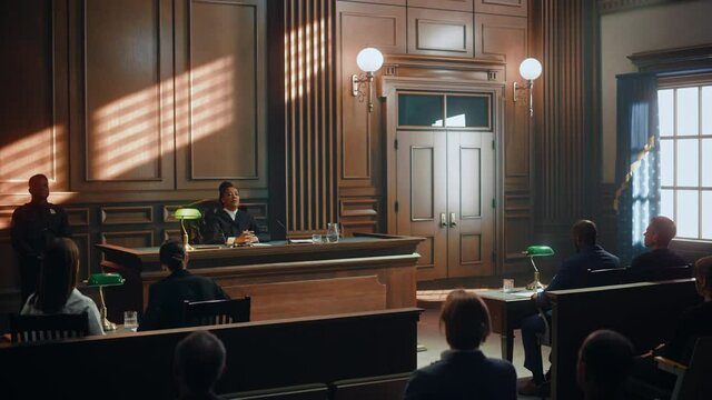 Court of Justice Trial: Impartial Judge Sitting Down, Public Sits Down on Benches After Her. Supreme Federal Court African American Judge Starts Civil Case Hearing with Striking a Gavel.