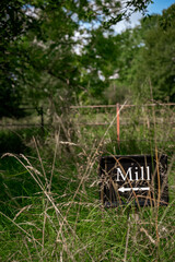 small black sign in long grass
