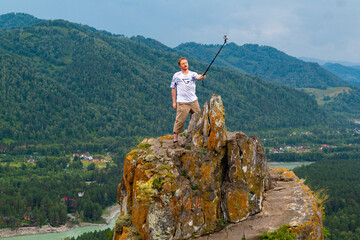 A man takes a dangerous selfie on Mountain of the Bloody finger in Altai, Russia, August