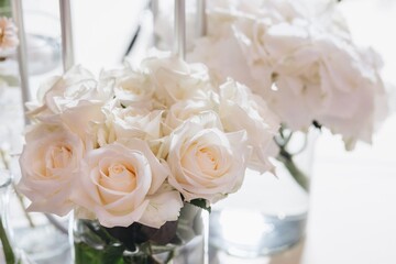 Romantic Wedding Table Top Layout Decor with large lush floral bouquets including white roses, ranunculus, persian buttercups, white orchids and candles