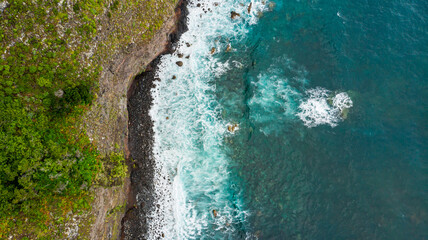 Amazing aerial view of crashing waves on rocks seascape.
