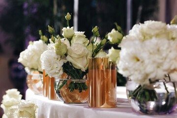 Romantic Wedding Table Top Layout Decor with large lush floral bouquets including white roses, ranunculus, persian buttercups, white orchids and candles