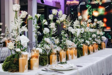 Romantic Wedding Table Top Layout Decor with large lush floral bouquets including white roses, ranunculus, persian buttercups, white orchids and candles