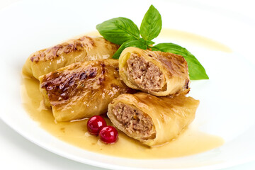 Stuffed cabbage rolls with sauce, isolated on white background.