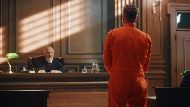 Court of Law and Justice Trial Proceedings: Law Offender in Orange Jumpsuit is Questioned and Giving Testimony to Judge, Jury. Criminal Denying Charges, Pleading, Inmate Denied Parole.