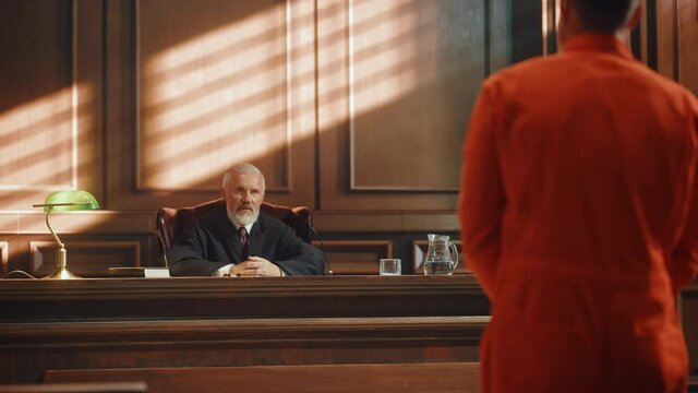 Court of Law and Justice Trial Proceedings: Law Offender in Orange Jumpsuit is Questioned and Giving Testimony to Judge, Jury. Criminal Denying Charges, Pleading, Inmate Denied Parole.