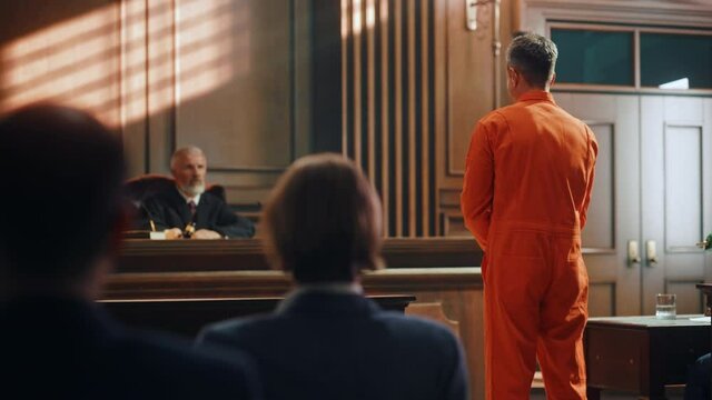 Court of Law and Justice Trial Proceedings: Law Offender in Orange Jumpsuit is Questioned and Giving Testimony to Judge, Jury. Criminal Denying Charges, Pleading, Inmate Denied Parole.
