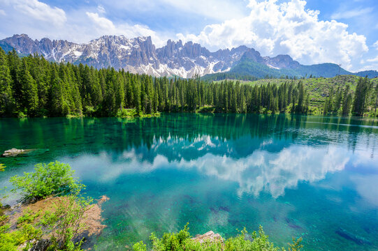 Paradise scenery at Karersee (Lago di Carezza, Carezza lake) in Dolomites of Italy at Mount Latemar, Bolzano province, South tyrol. Blue and crystal water. Travel destination of Europe.