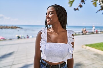 Young african american girl smiling happy standing at the promenade. © Krakenimages.com