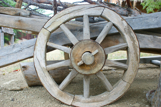 old (vintage) wooden wheel. 19th century wagon wooden wheel. antique metal parts made in the forge