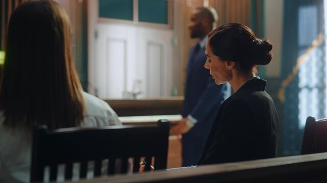 Court of Justice and Law Trial: Female Prosecutor Listening and Writing Down Notes to the Case Presented by Lawyer to Judge, Jury. Attorney Lawyer Protecting Client with Closing Not Guilty Arguments.