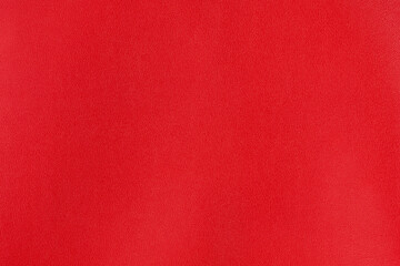 Crimson red textured smooth leather surface background, small grain