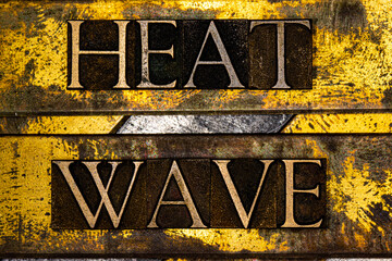 Heat Wave text on vintage grunge textured copper and gold background