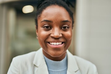 Young african american businesswoman smiling happy standing at the city.