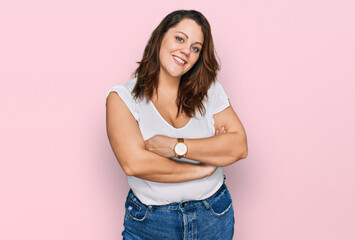 Young plus size woman wearing casual white t shirt happy face smiling with crossed arms looking at the camera. positive person.