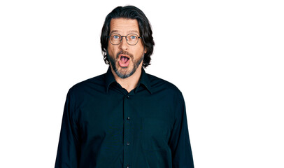 Middle age caucasian man wearing casual clothes and glasses afraid and shocked with surprise expression, fear and excited face.