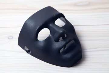 black mask of anonymous on the table