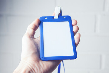 hand holding id tag