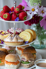 Afternoon tea with cakes and sandwiches