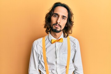 Young hispanic man wearing hipster elegant look relaxed with serious expression on face. simple and natural looking at the camera.