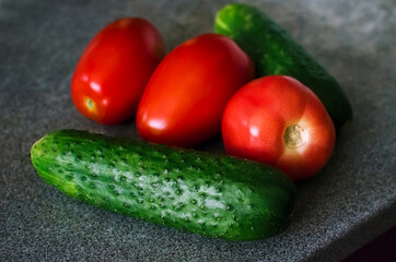 Whole tomatoes and cucumbers. Top view point.