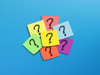 Note papers with question mark on blue background